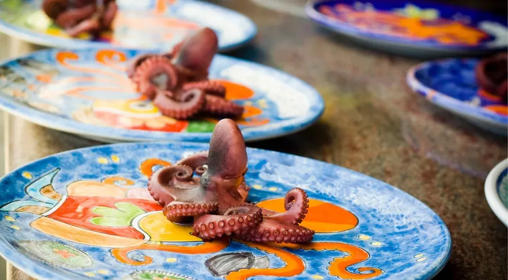 Boiled octopus being cut at a Palermo market stall