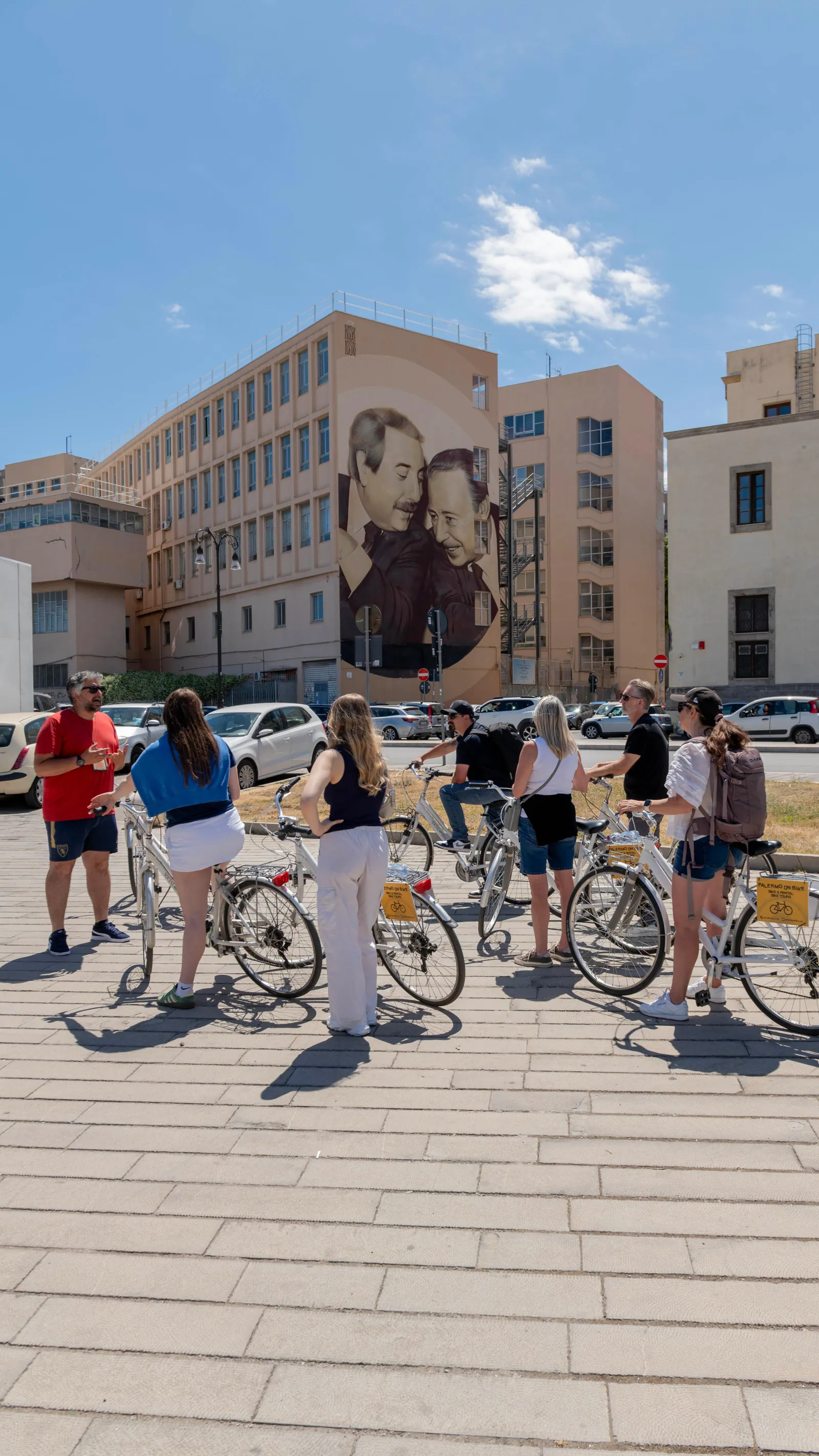 Riders beside a street mural