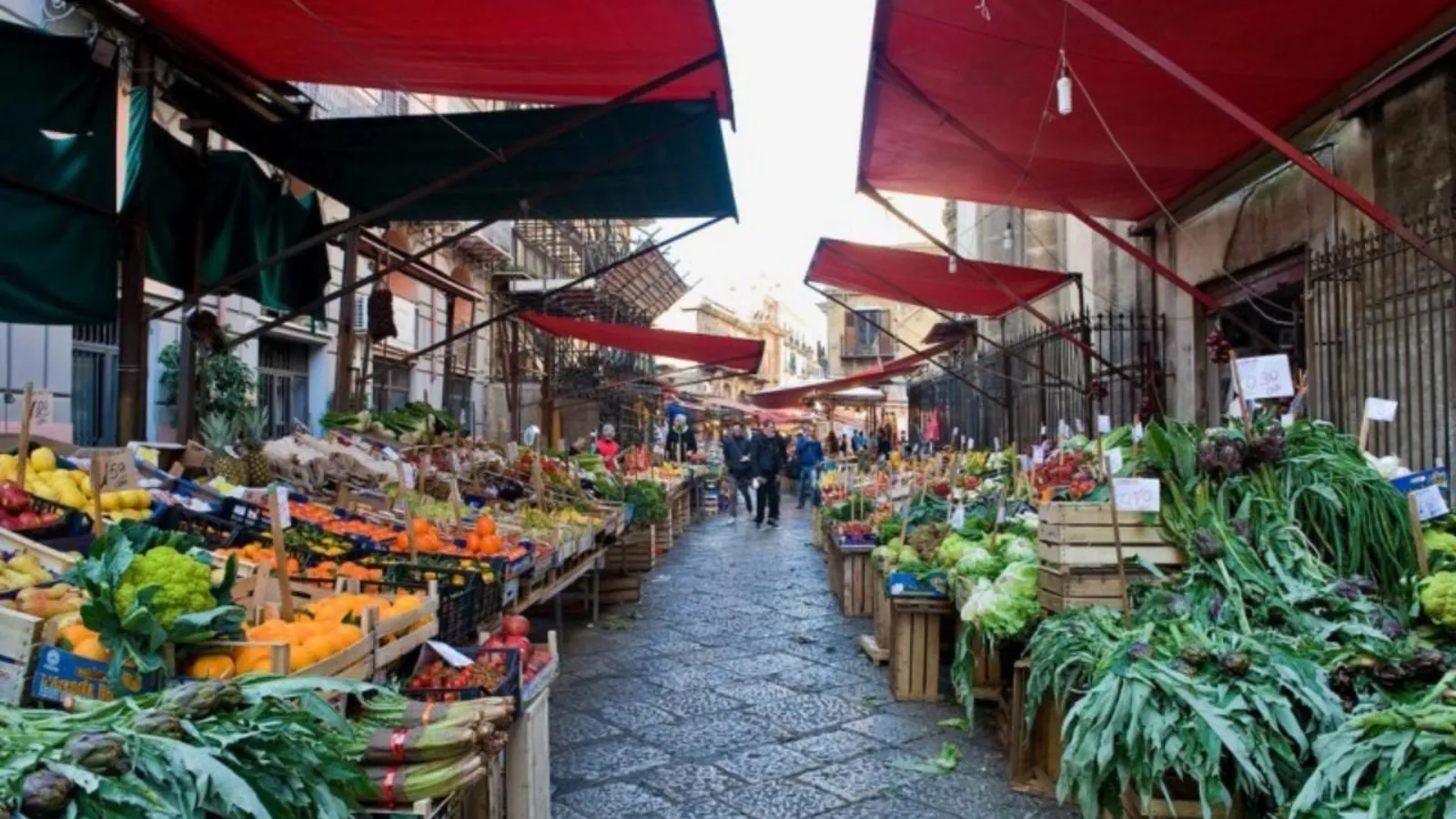 Fruit and vegetable stalls along a Palermo market street