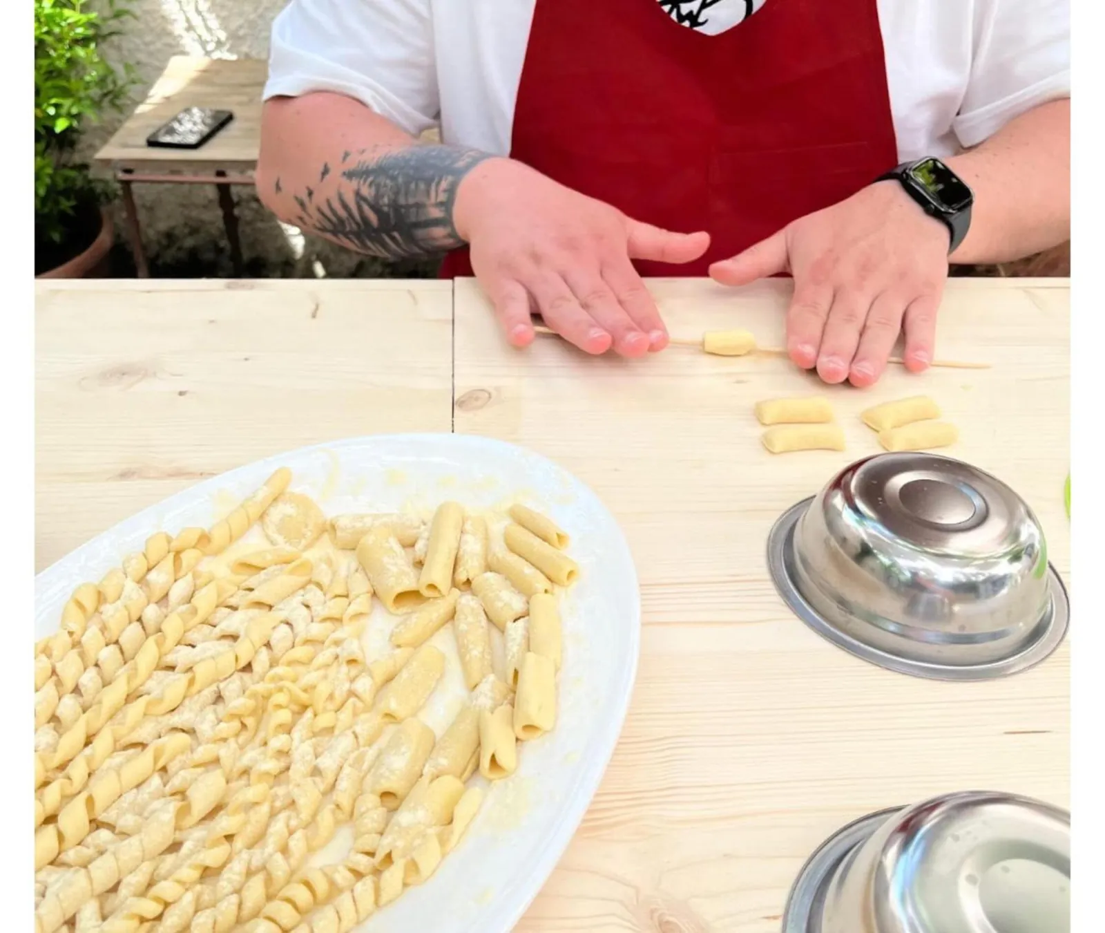 Shaping fresh pasta by hand on a wooden board
