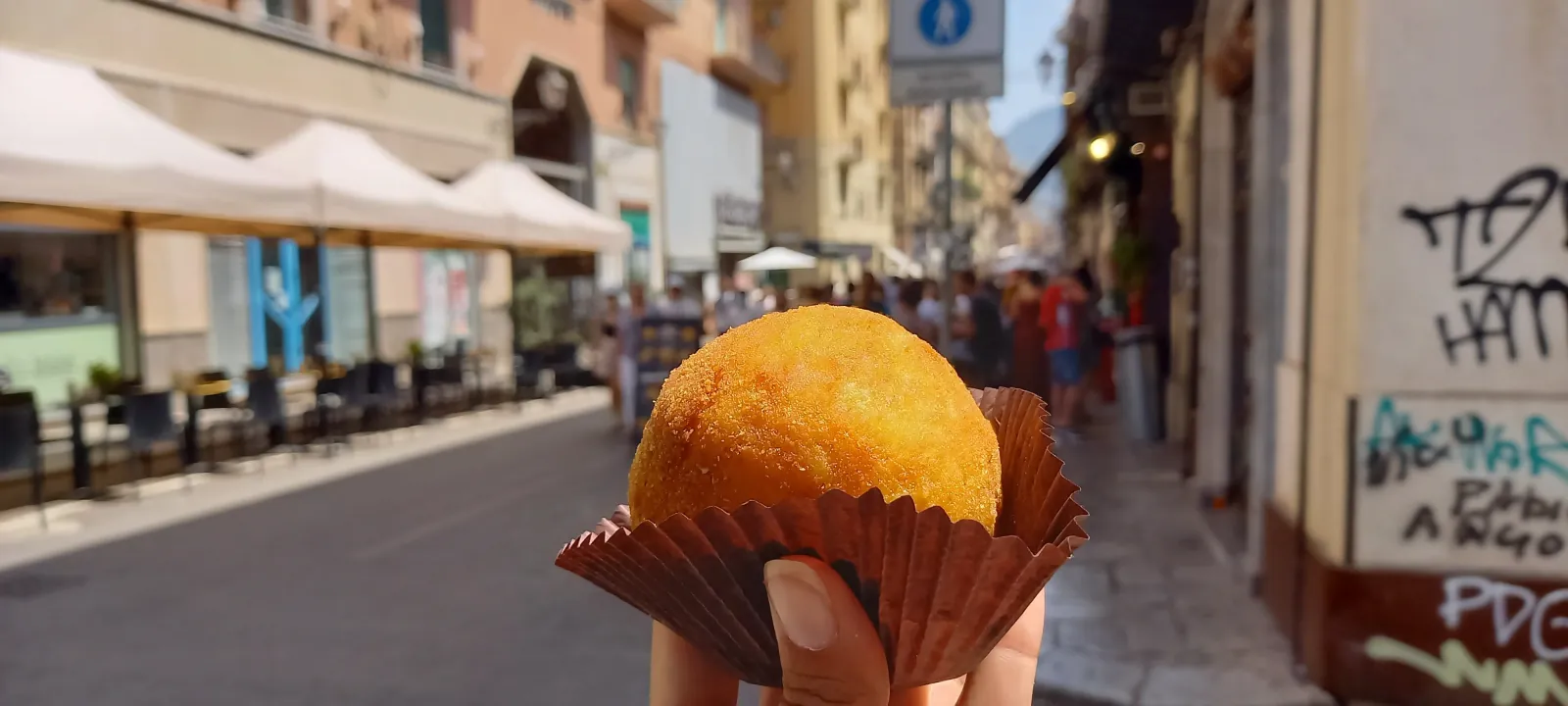 An arancina held up on a Palermo street