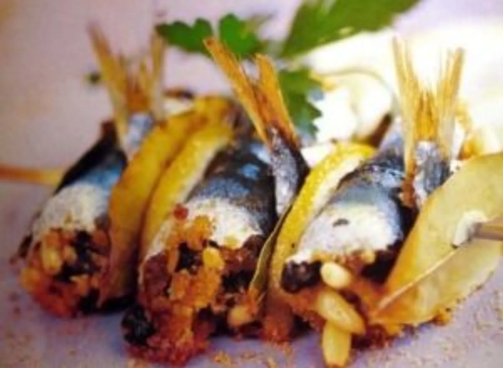 Sarde a beccafico, rolled stuffed sardines with bay leaves