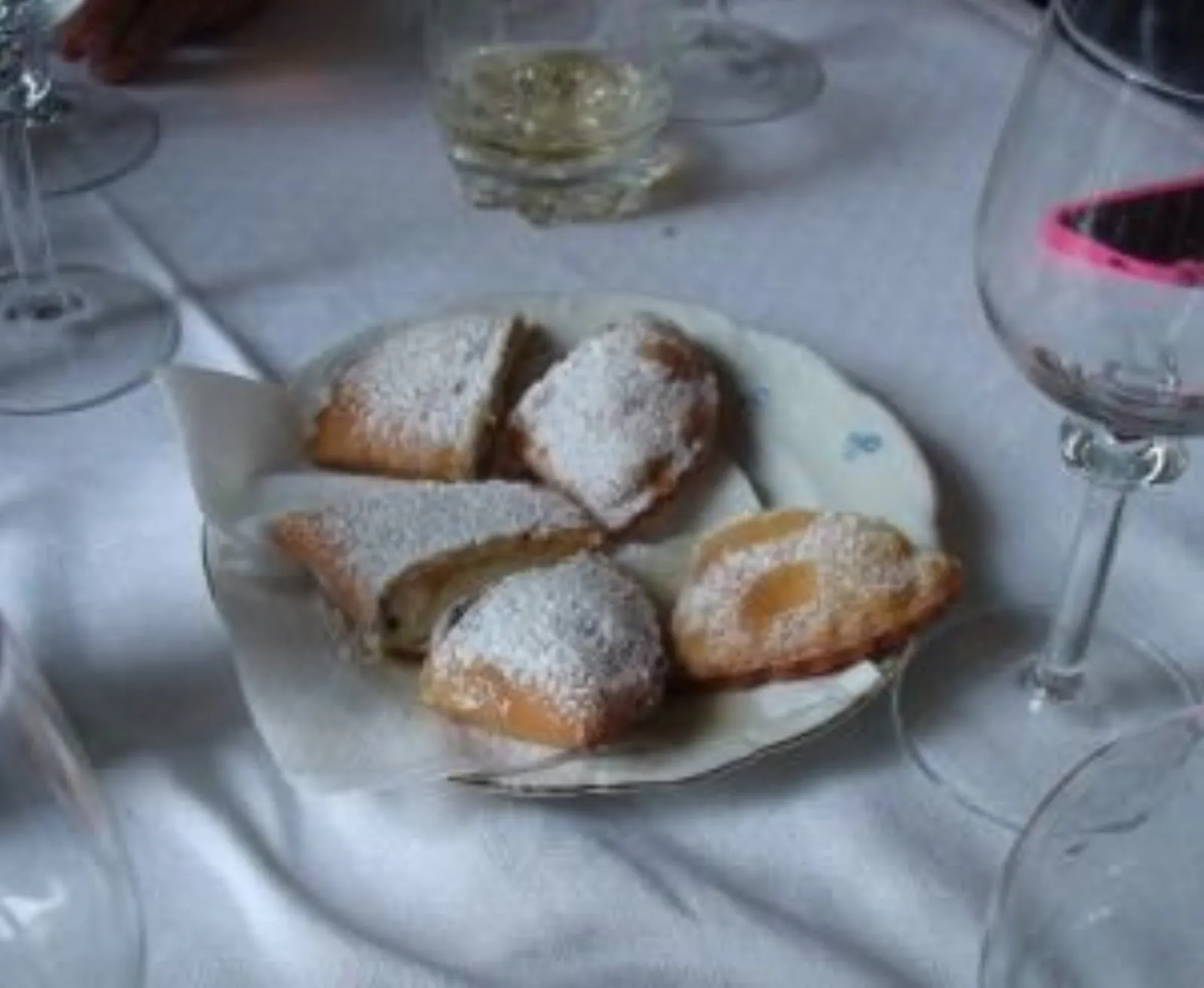 Sugar-dusted Sicilian pastries served with wine