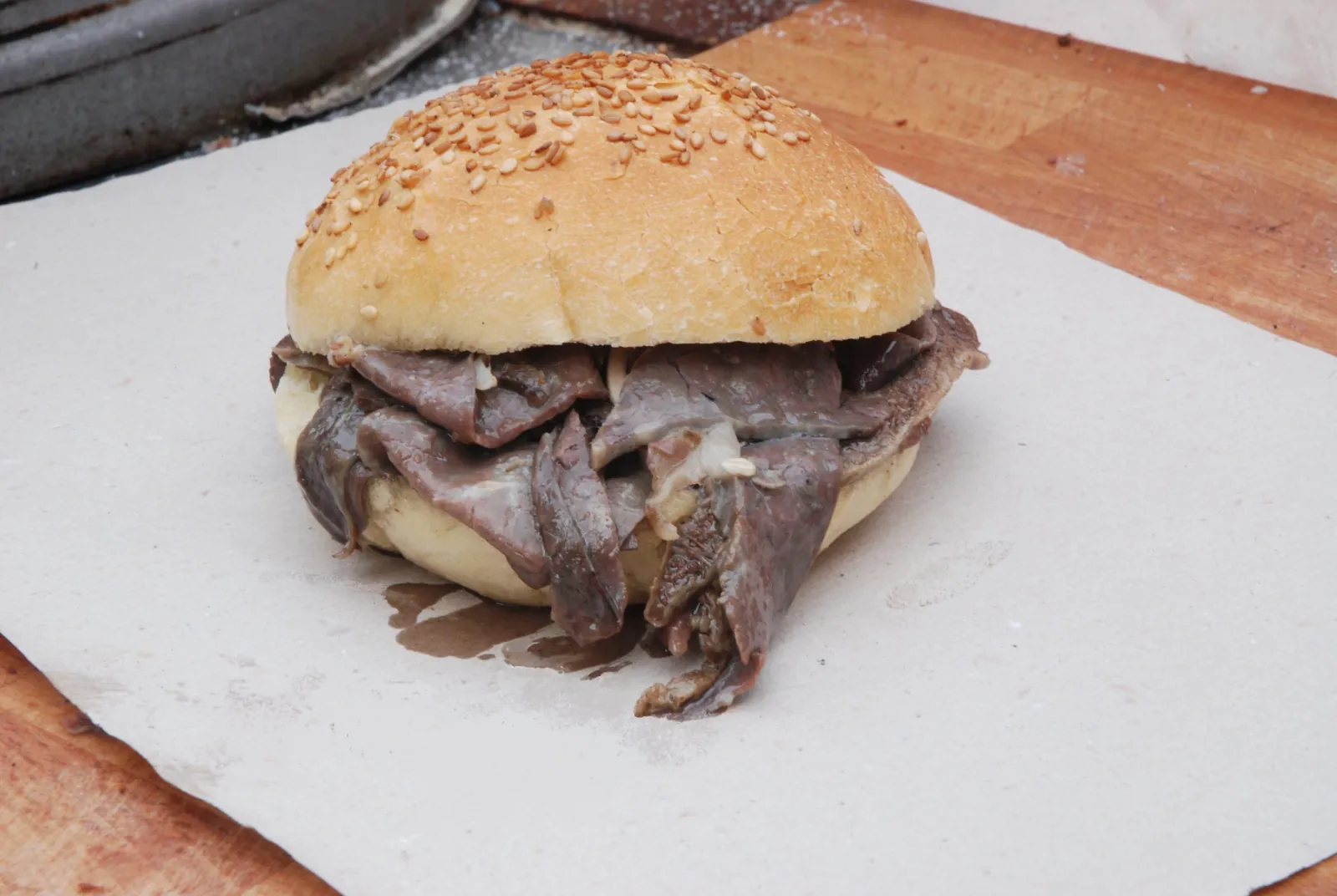 A pani ca meusa sandwich on a paper wrapper
