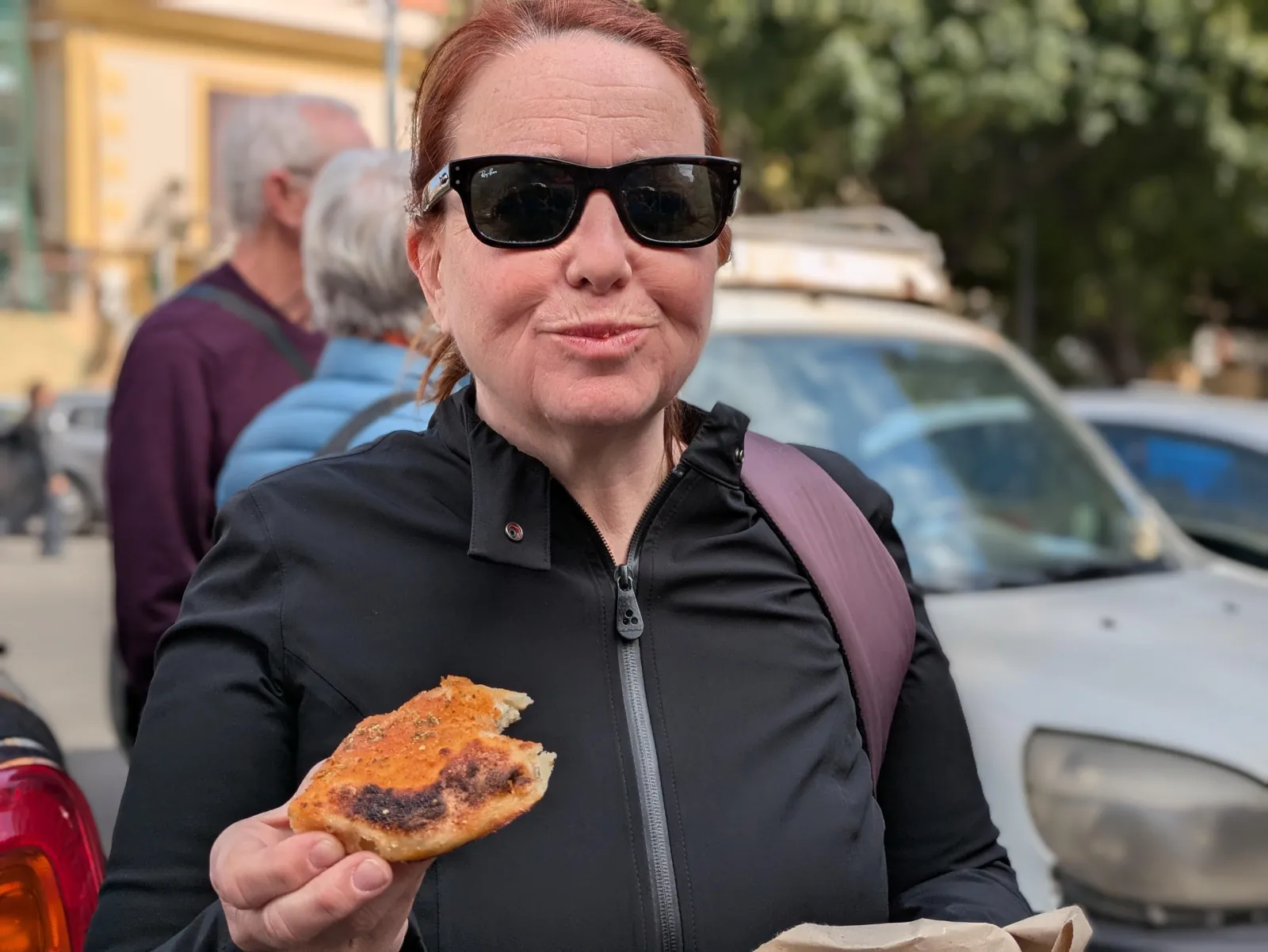 A guest tries a slice of sfincione during the tasting stop