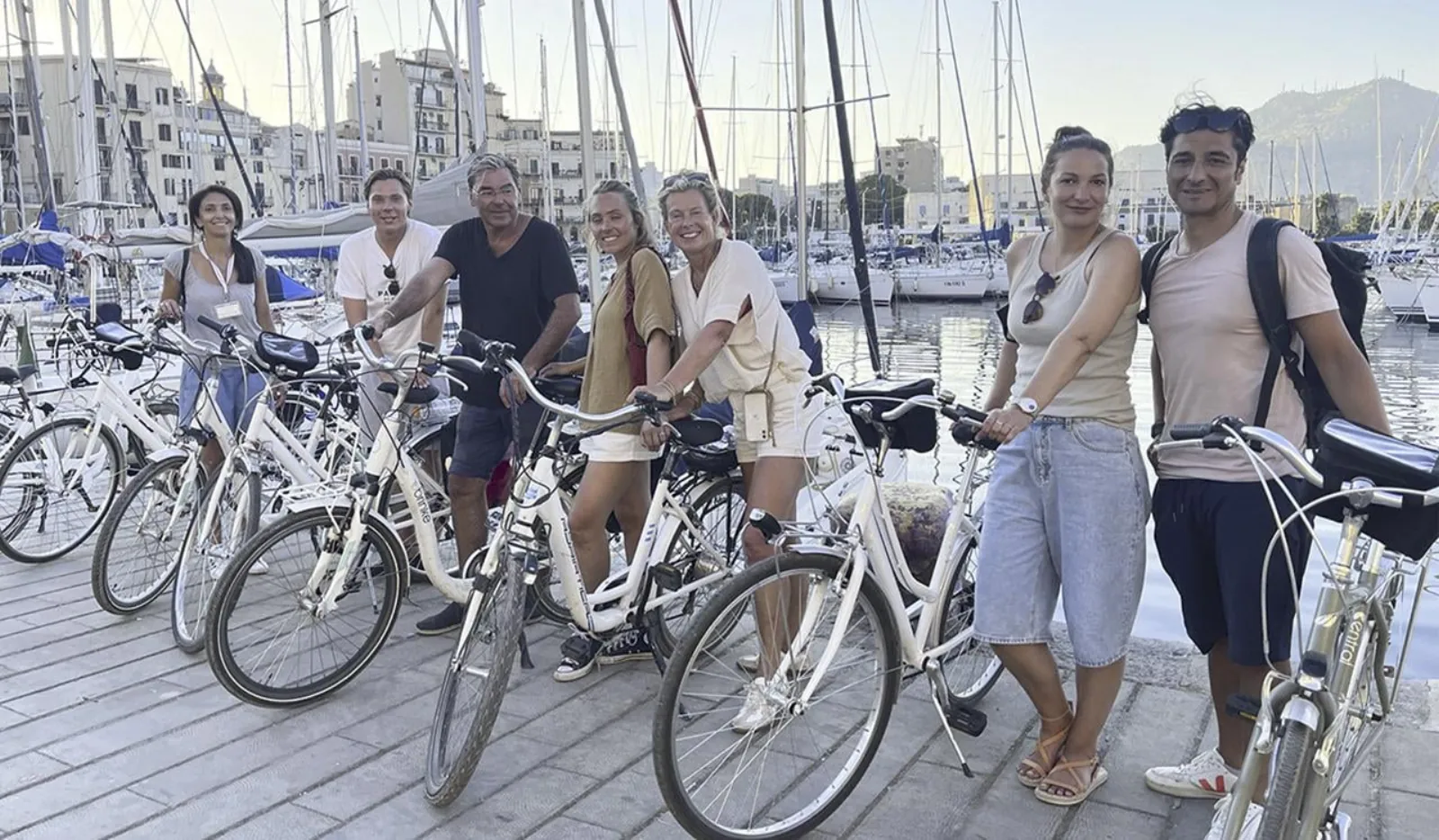 The bike group lined up on the harbour boardwalk