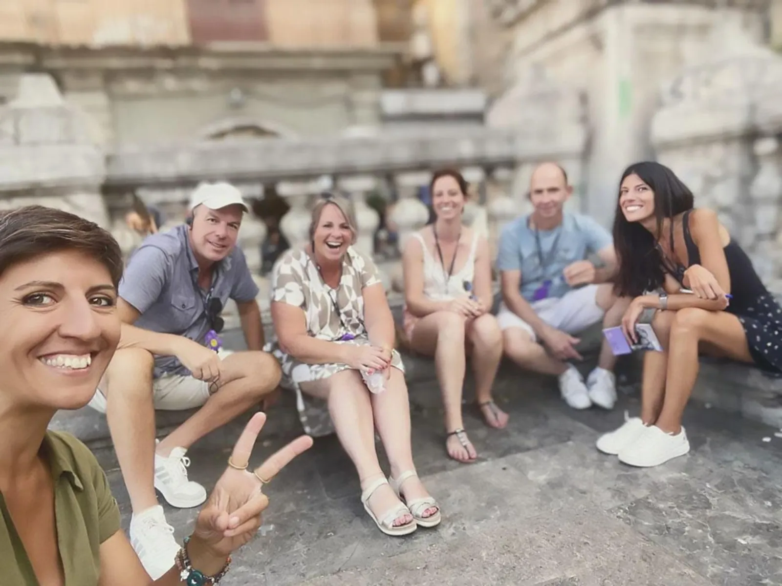 The bike group resting on stone steps in the old town