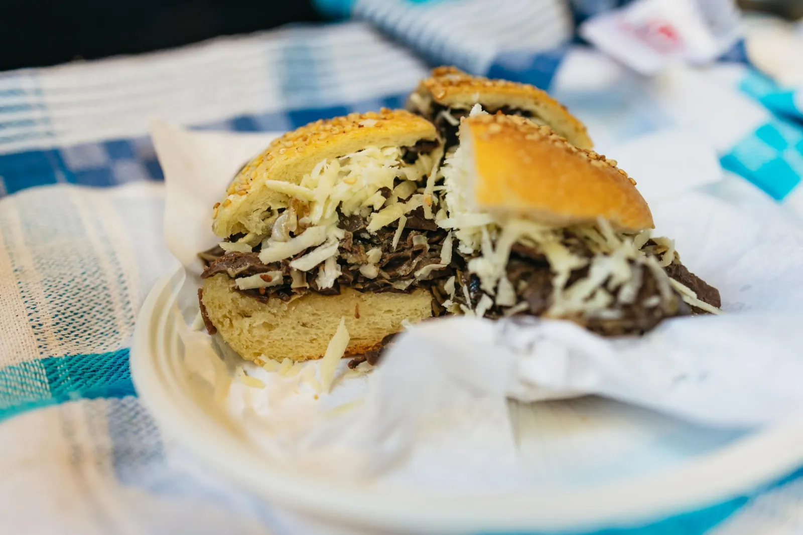 A pani ca meusa spleen sandwich topped with grated cheese