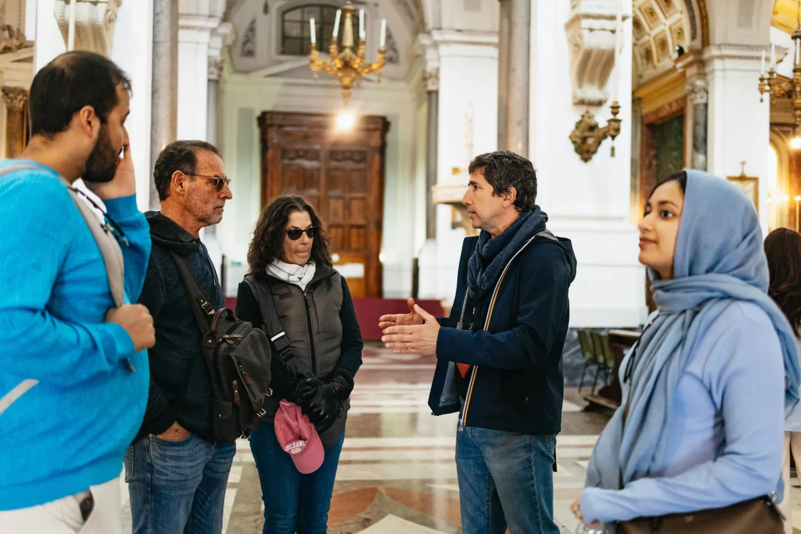 The guide talks to the group inside Palermo Cathedral