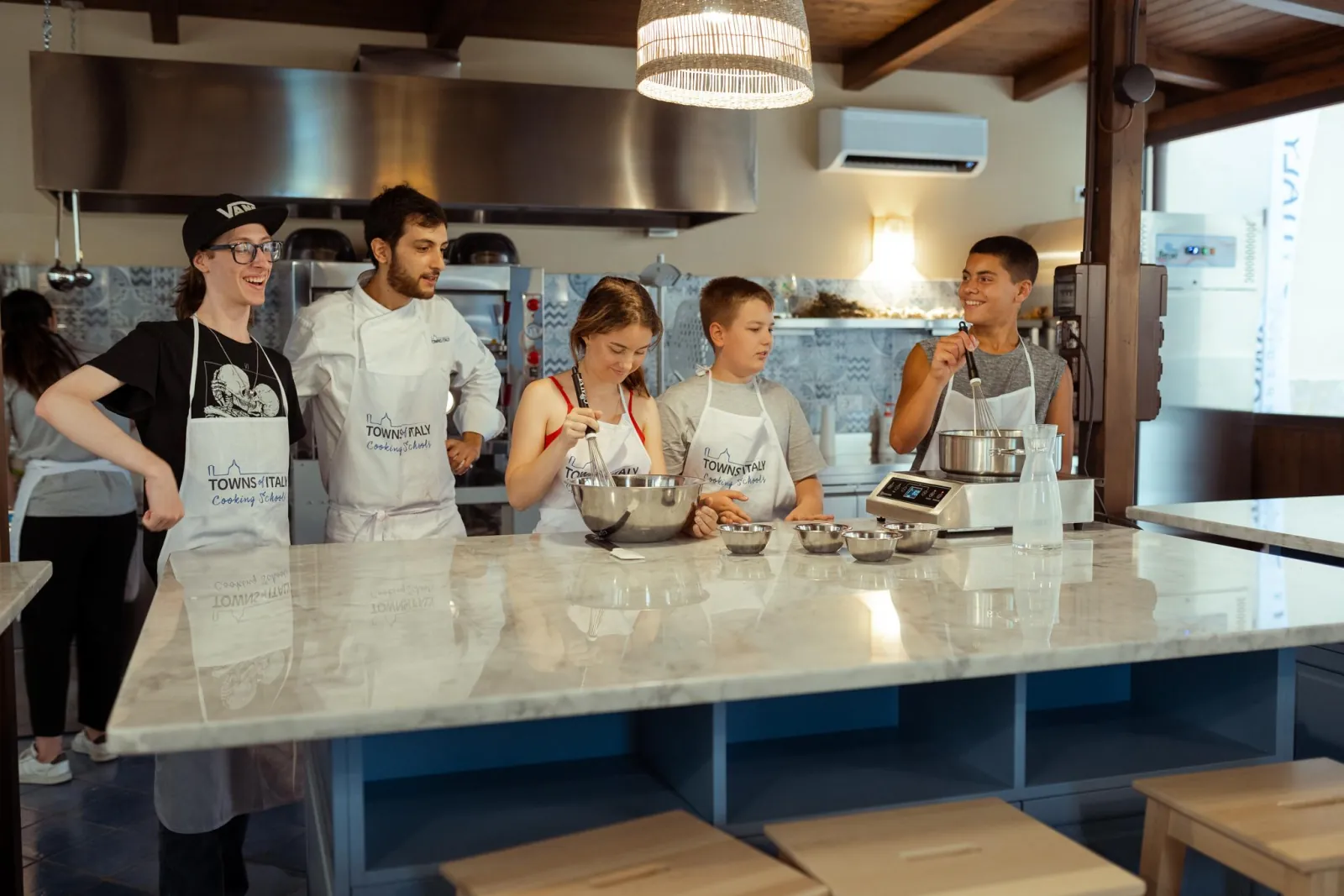 A group at the work counter in the cooking school kitchen