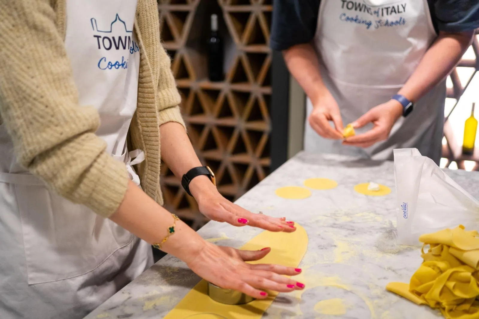 A guest rolling out fresh pasta dough by hand