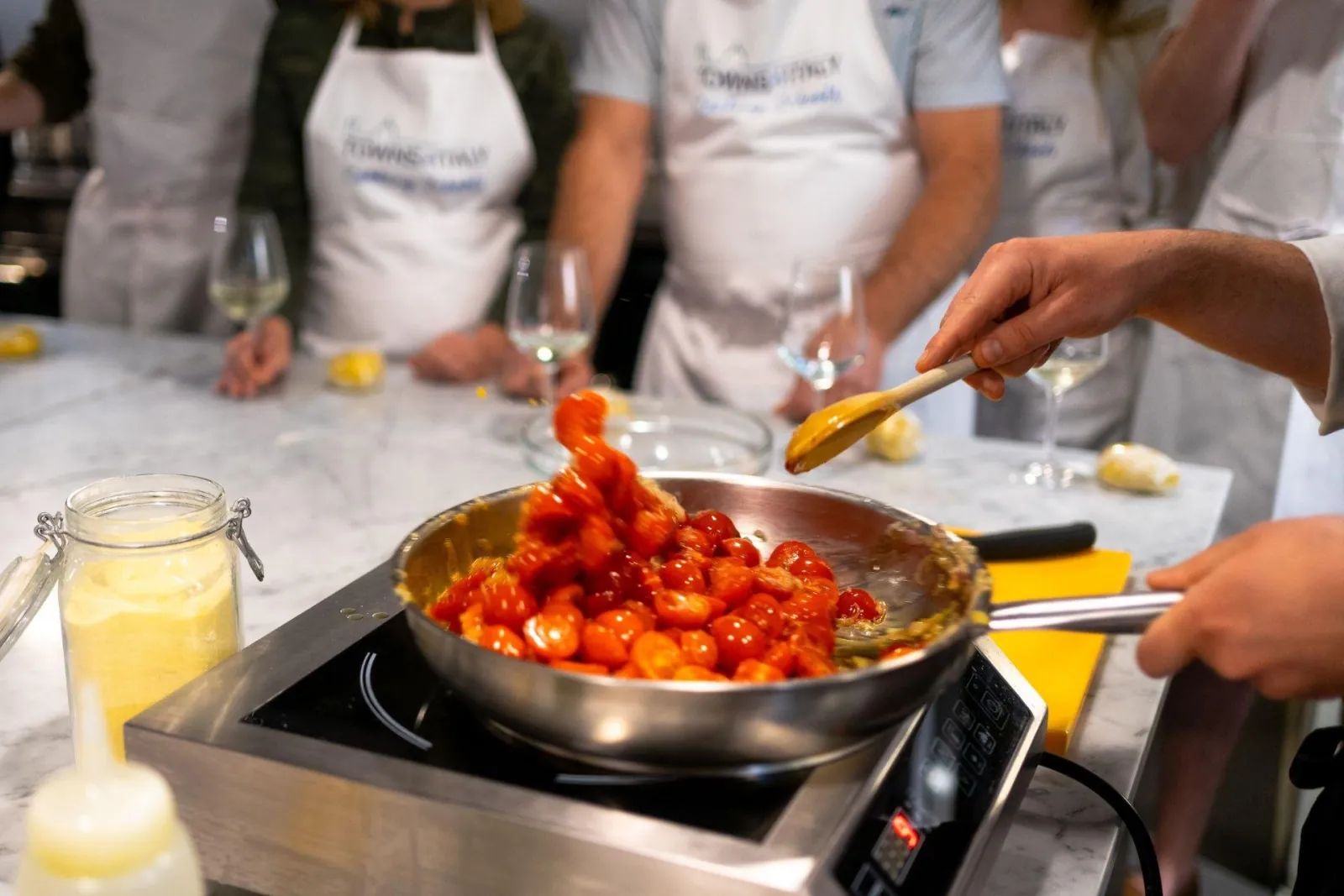 Cherry tomatoes cooking down in a pan for the sauce